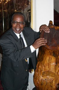 Apollo tour guide Billy Mitchell rubbing the Stump for good luck.