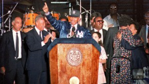 Nelson Mandela at podium, flanked by Mayor Dinkins, at Yankees Stadium.  (Photo credit: CBS/NY).