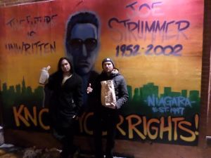 In front of the old Joe Strummer mural on East 7th. Too old for 40s- we're baggin' cheese fries and fried oreos.